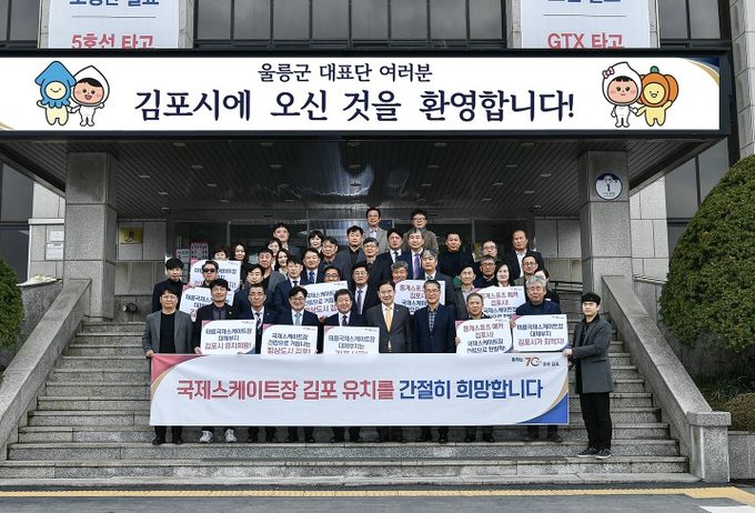 김포시와-울릉군의 친선 결연 협약식을 위해 지난 28일 김포시를 찾은 남한권 울릉군수를 비롯한 울릉군 체육회 인사들은 협약식을 마치고 김포시의 국제스케이트장 유치를 응원하며 현수막과 피켓을 들었다.